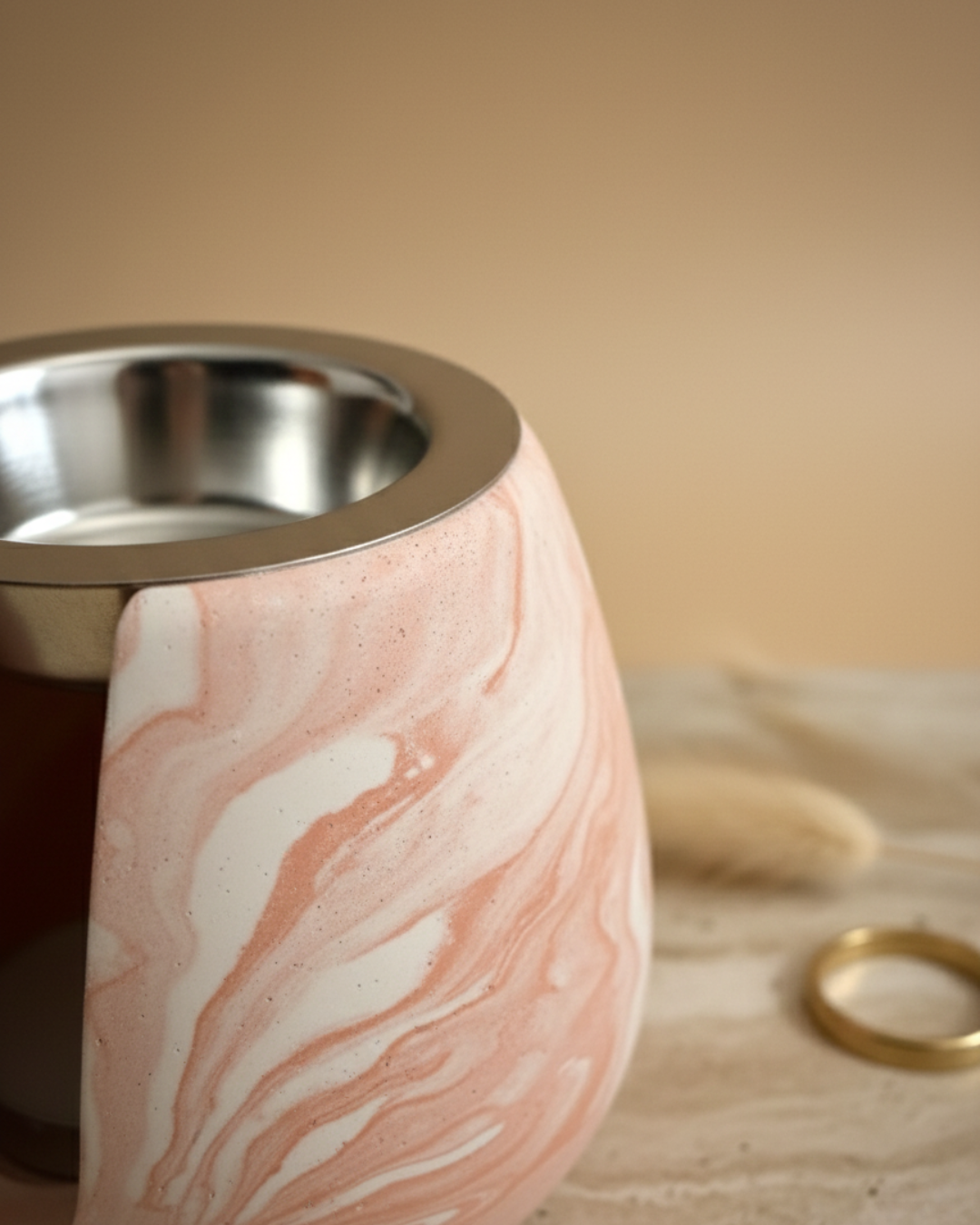 Gros plan sur la texture marbrée terracotta et blanc du brûleur artisanal en jesmonite Casarte.